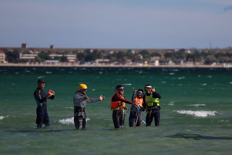 A Group Of People Engaged In Water Sports