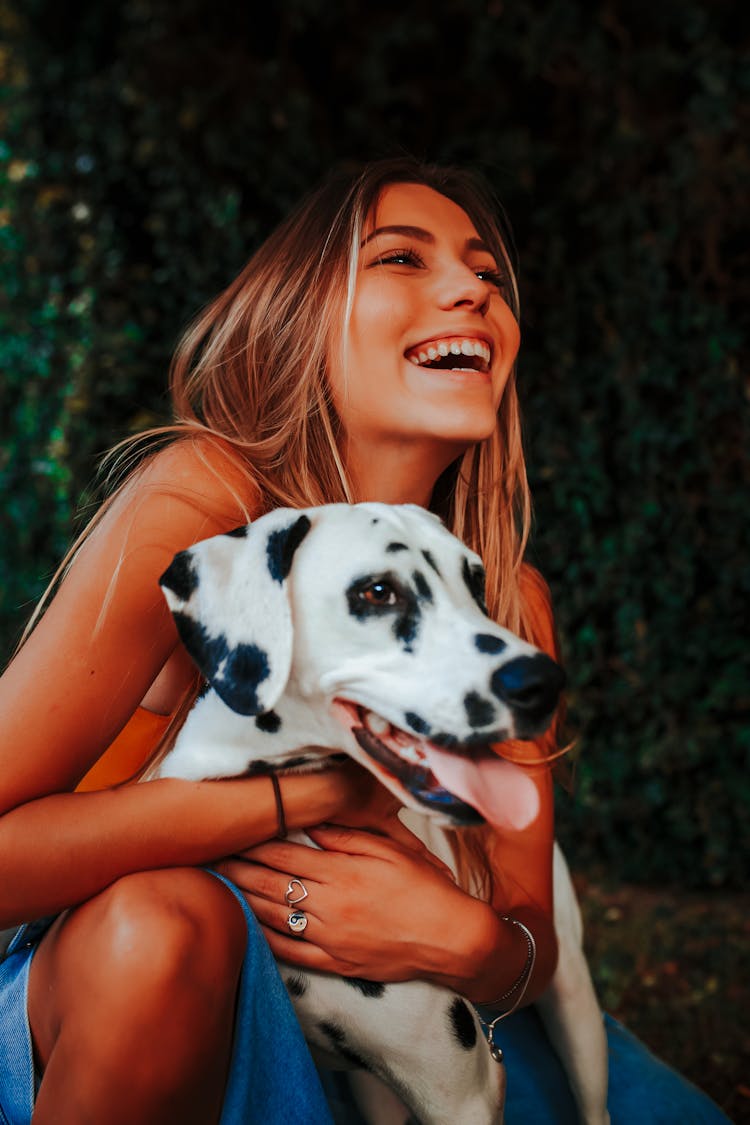 Woman Holding Dog And Laughing