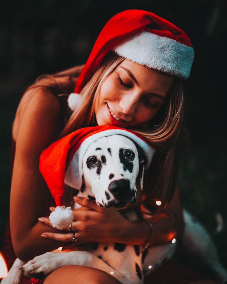 Woman And Dog In Christmas Hats