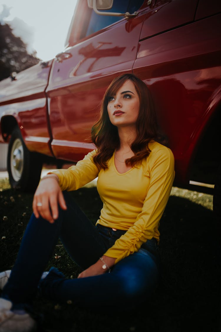 Woman Sitting Next To Car