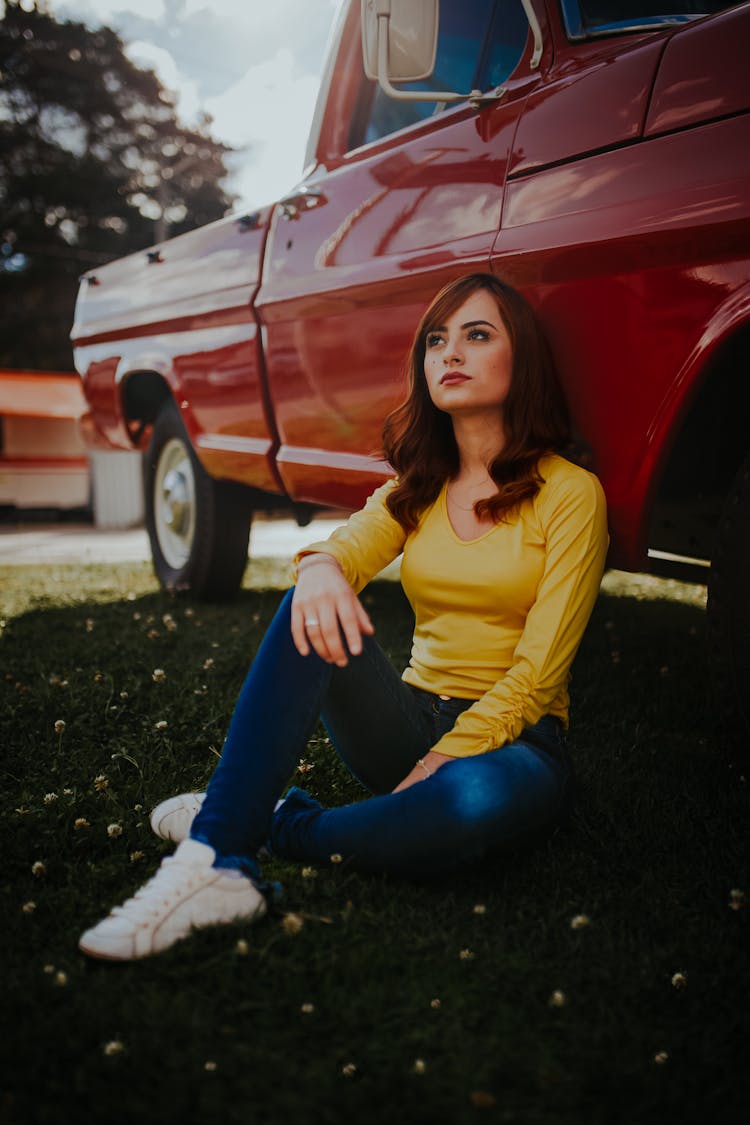 Woman Sitting Next To Car