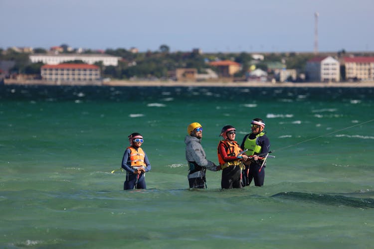 Men Teaching A Woman In Kitesurfing