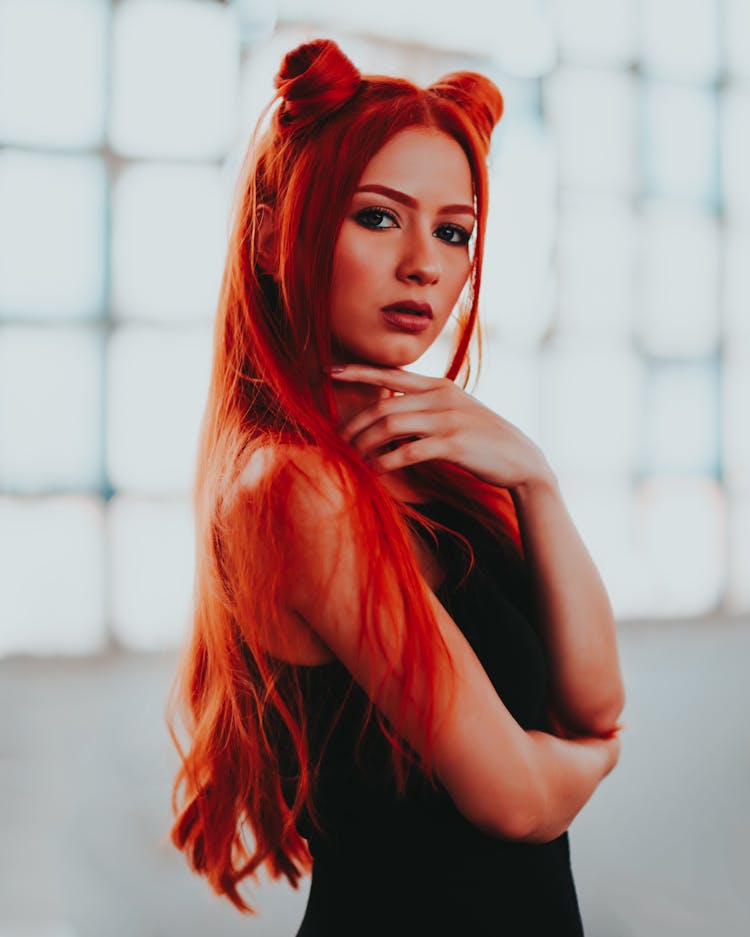 Woman Posing With Red Hair Stylized As Horns