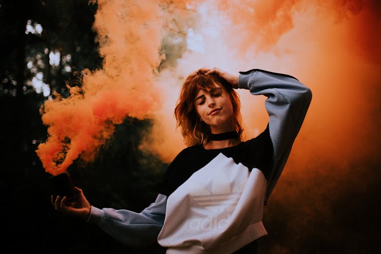 Girl In Sweatshirt Holding Smoke Candle