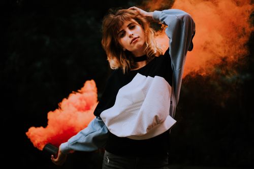 Free Dramatic portrait of a woman with smoke effect, evoking a modern fashion concept. Stock Photo