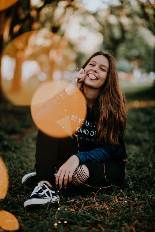 A Young Woman Sitting on Grass · Free Stock Photo