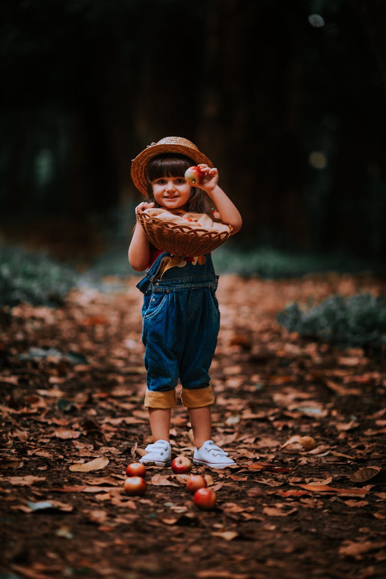 A Girl Holding An Apple