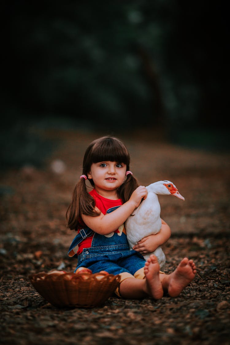 Girl Sitting With Bird