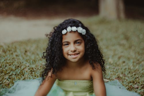 A Young Girl with Curly Hair in Headband 