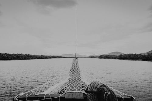 Black and White Photo of Boat on River