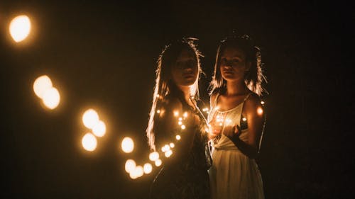 Girls Posing with Lights in Dark