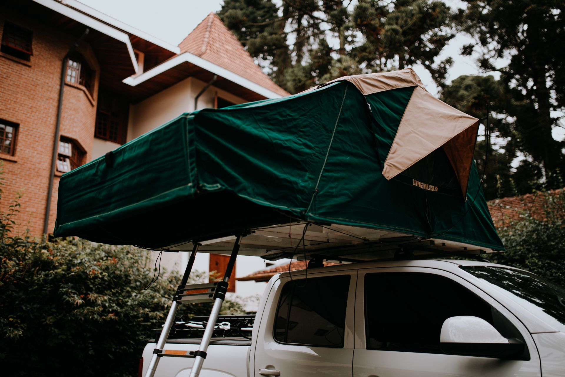 Rooftop car tent setup for an adventurous camping trip outdoors.