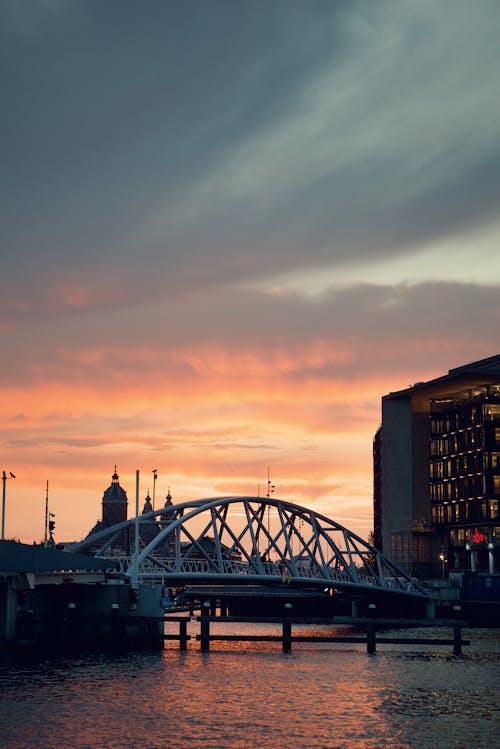 View of a Bridge and Buildings in City at Sunset 