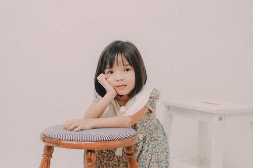 Little Girl Leaning on a Stool