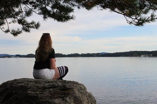 Woman Sitting on a Rock