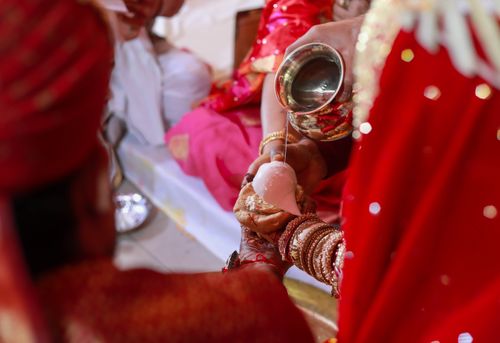 Free Close-up of a ritual pouring ceremony at a traditional Indian wedding, symbolizing spiritual unity. Stock Photo