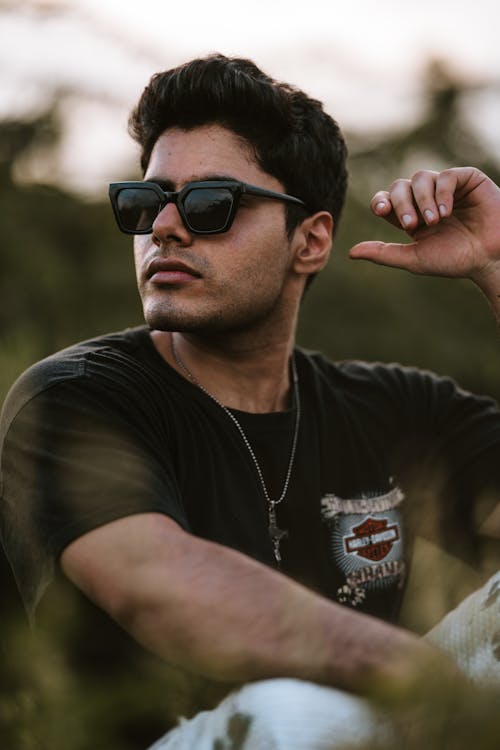 Man Wearing Sunglasses Posing Outdoors