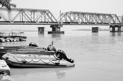 Grayscale Photo of Boat on Water