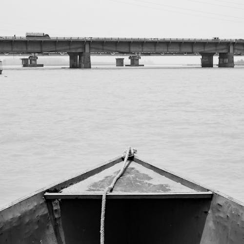 A Grayscale Photo of a Boat on the Sea