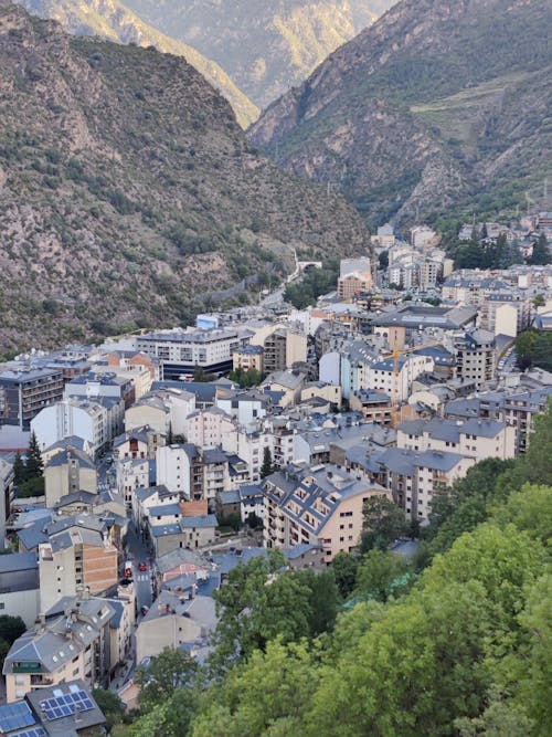 Aerial View of Concrete Buildings Near Mountain