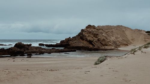 Free Tranquil beach with rock formations in Kareedouw, Eastern Cape, South Africa. Stock Photo