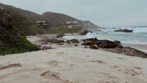 Free Peaceful beach landscape with rocks and houses in Kareedouw, Eastern Cape. Stock Photo