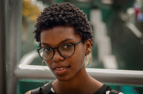 Free Close-up outdoor portrait of a beautiful woman with eyeglasses in Santo Domingo. Stock Photo