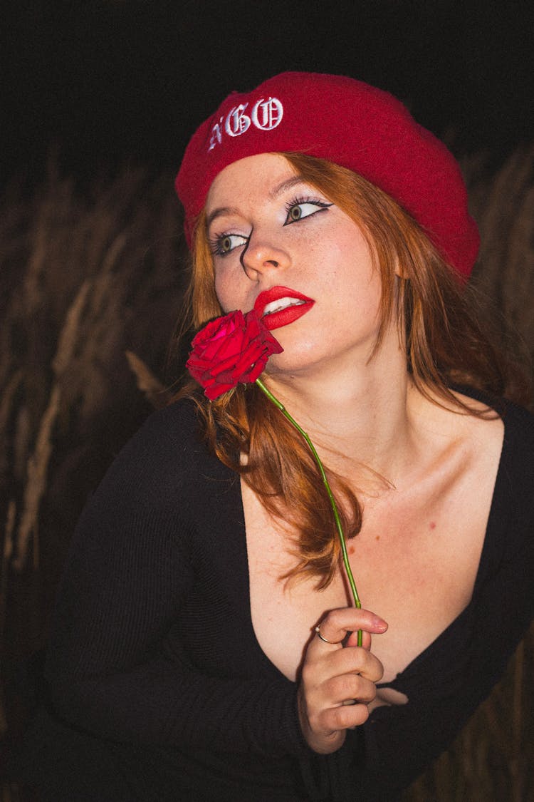 A Woman Holding A Red Rose