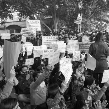 Grayscale Photo of People Gathering on Street