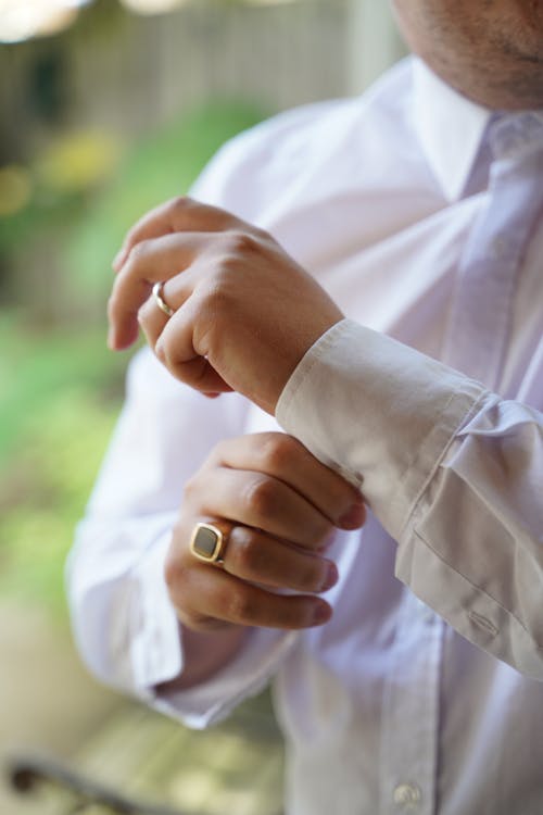 Man Buttoning his Shirt Cuffs