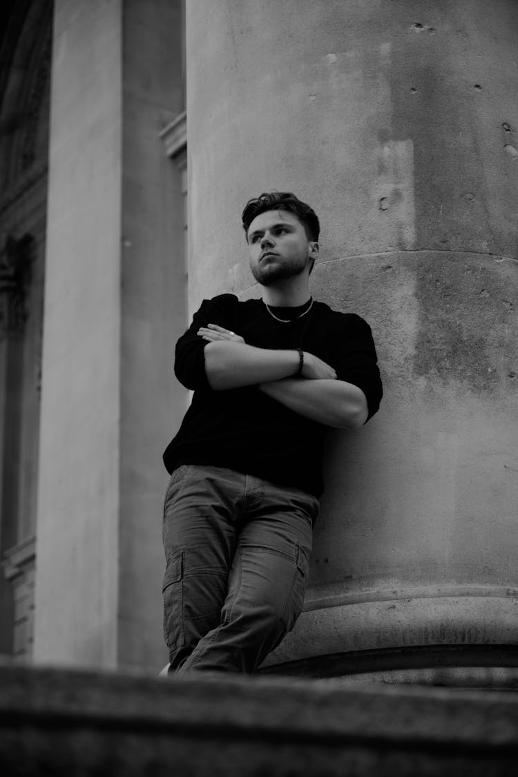 Man Posing Near Column Outdoors