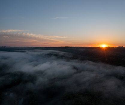 Experience a foggy sunset view over the peaceful landscapes of Maiden Rock, WI.