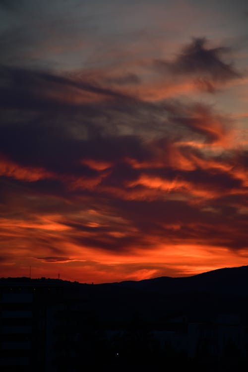 Bright Pink Sunset Sky over Silhouetted Hills 