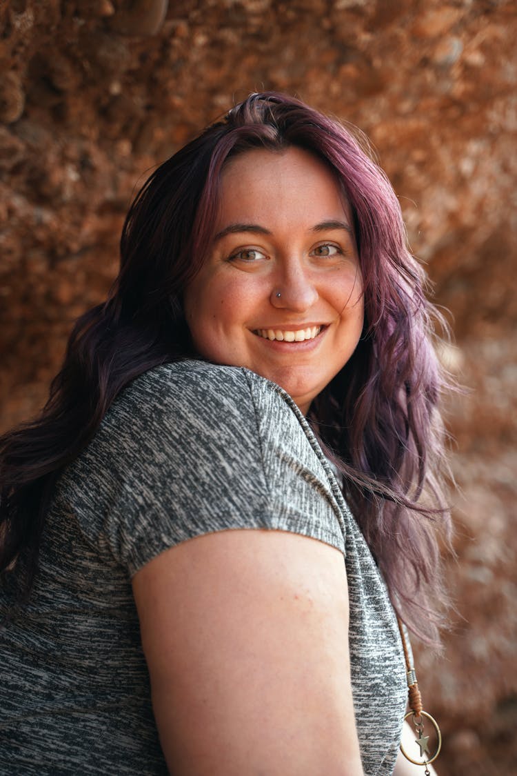 Portrait Of A Woman Smiling In Gray Shirt