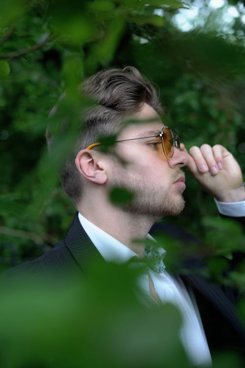 Free A Man in Black Suit Holding His Sunglasses Stock Photo