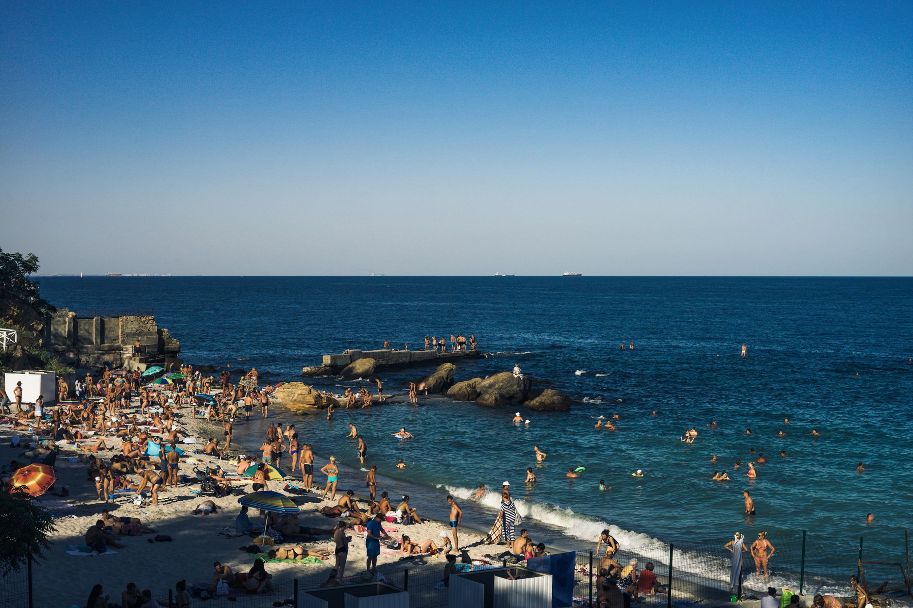 A lively summer day at a crowded beach in Odesa, Ukraine, by the Black Sea.
