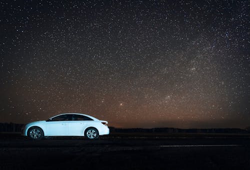 White Car Parked under a Starry Sky