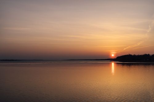 Free A breathtaking sunset over the tranquil waters of Minsk Reservoir, capturing serene beauty and reflection. Stock Photo