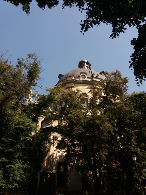 Free A stunning view of a domed building surrounded by trees under a clear blue sky in Lviv, Ukraine. Stock Photo