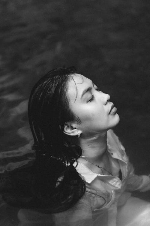 Grayscale Photo of Woman in Water