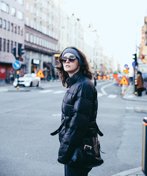 Woman in a Black Jacket Wearing Sunglasses