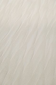 Close-up of wavy patterns in the sand at Tulum Beach, capturing natural textures.