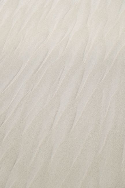Close-up of wavy patterns in the sand at Tulum Beach, capturing natural textures.