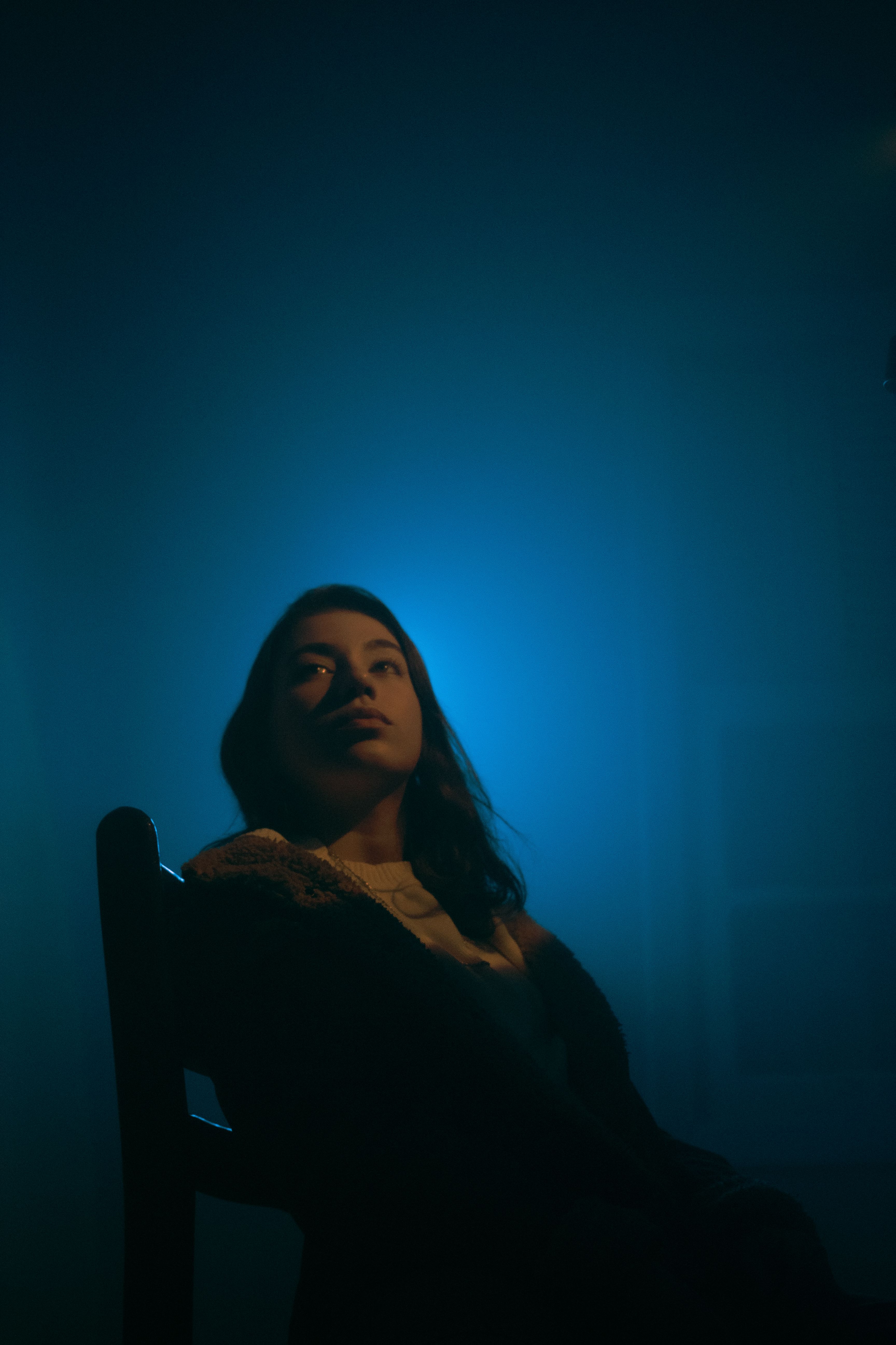 Woman Sitting on a Chair in Blue Lighting · Free Stock Photo