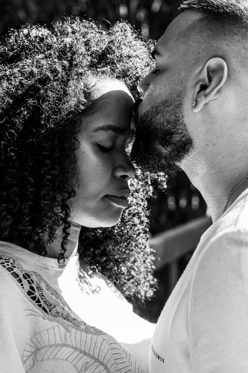 A Man Kissing a Woman's Forehead