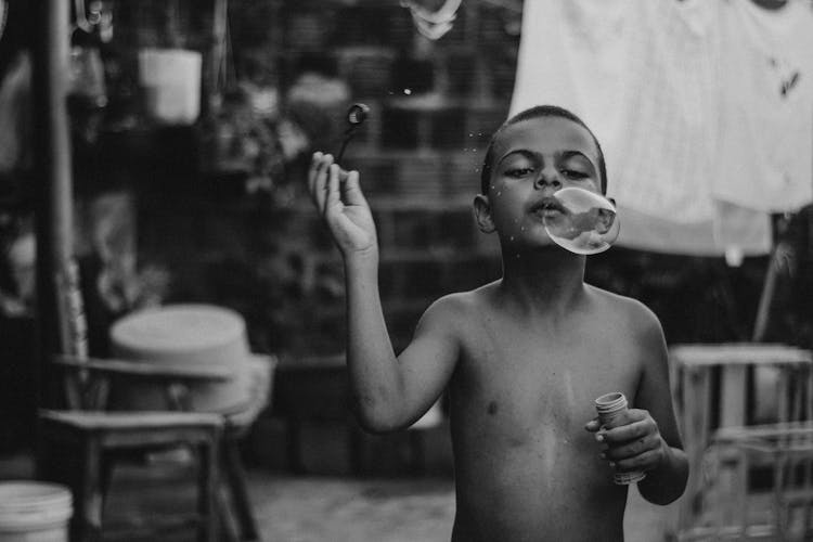 Boy Blowing Bubbles Outdoors