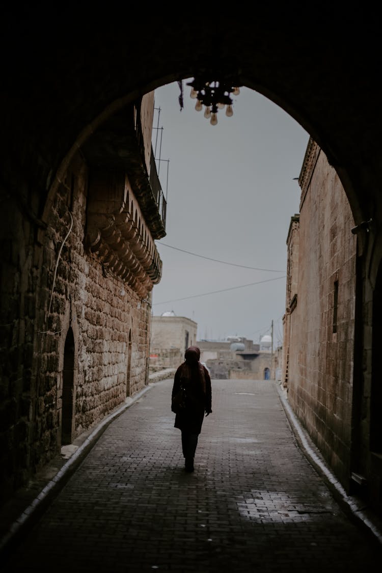 Silhouette Of A Person Entering A Tunnel