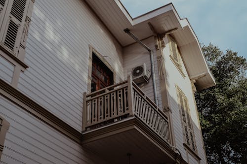 A Low Angle Shot of a White House with Balcony