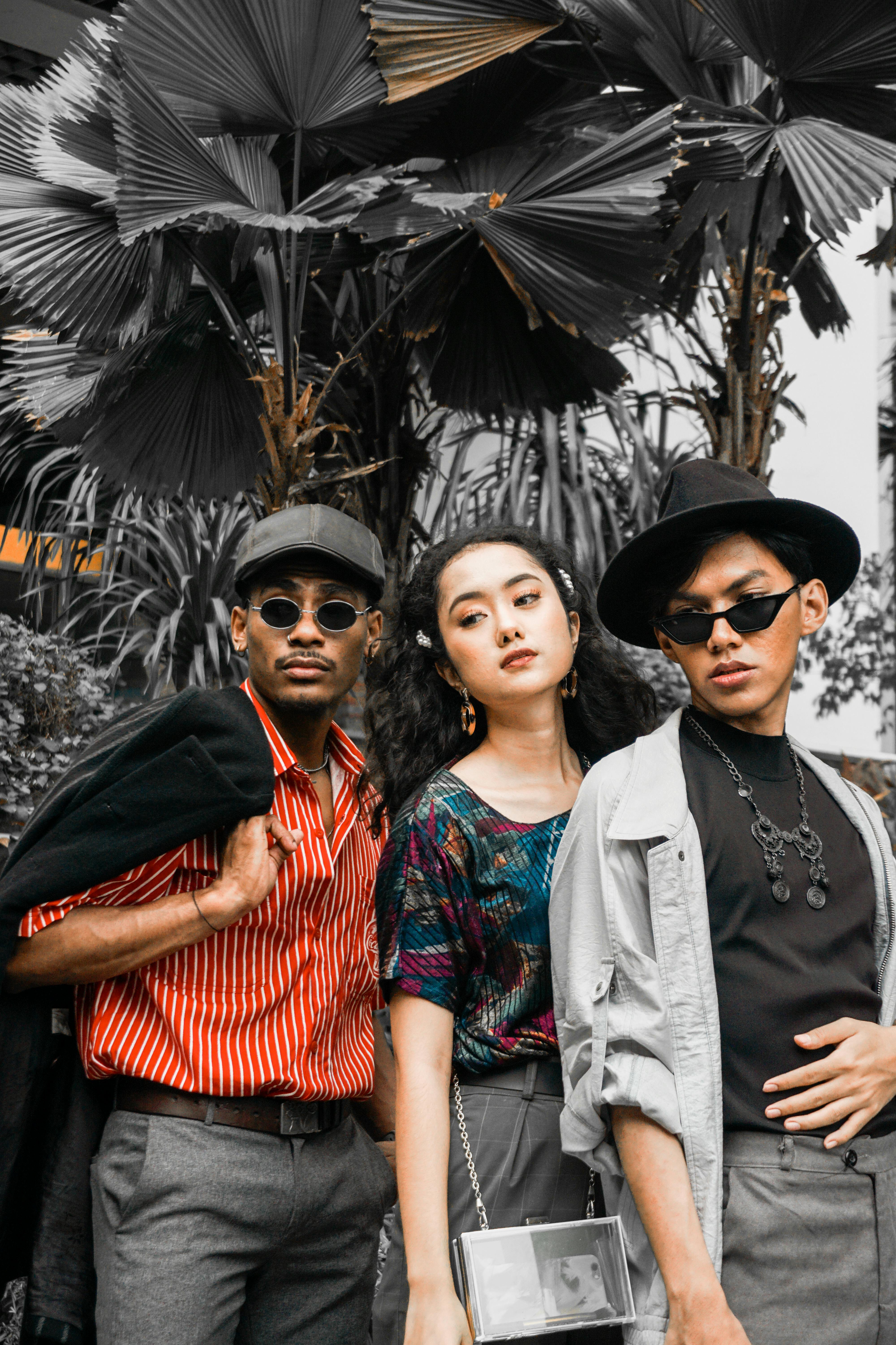 Trendy group of adults in urban fashion outdoors, showcasing bold creative style.