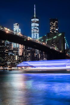Stunning night view of Brooklyn Bridge with New York City's illuminated skyline.